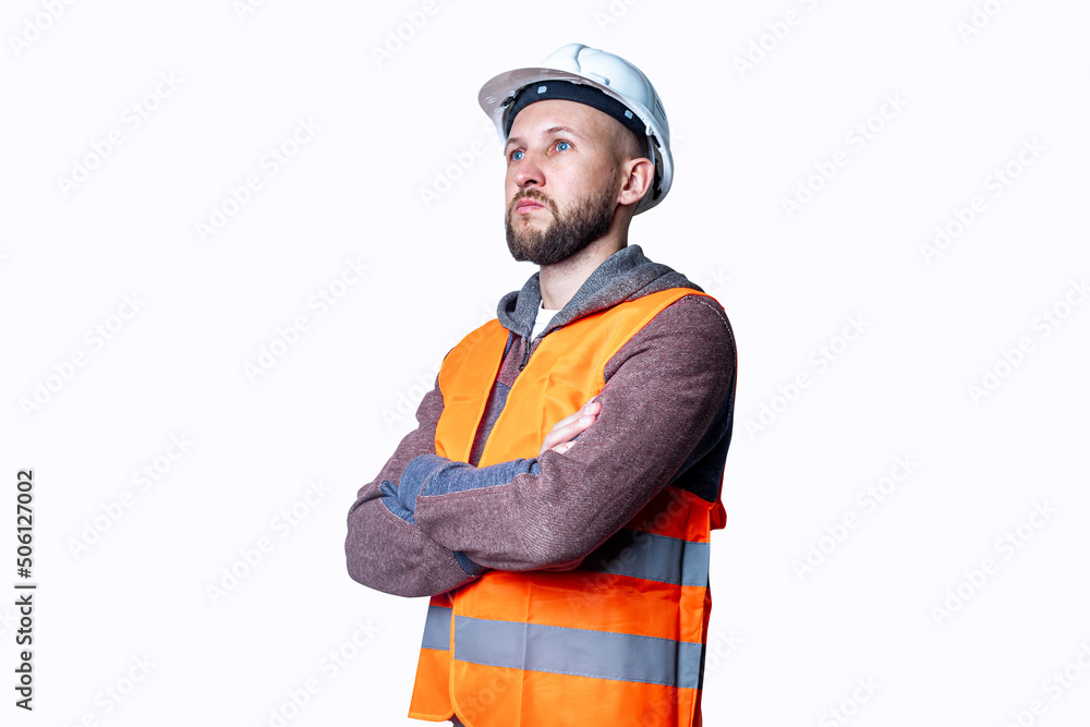 Fototapeta premium Young male civil engineer in helmet with crossed arms on light background.