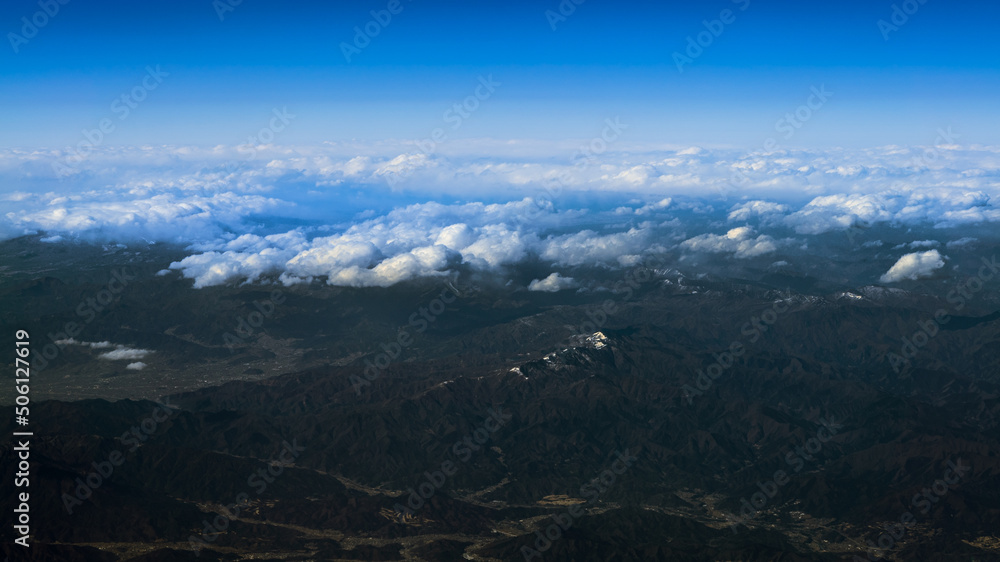 Wonderful landscape with japanese summit mountains above dense low clouds. Japan