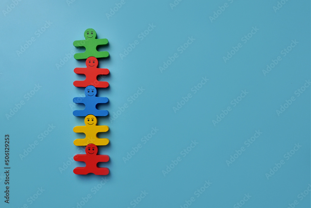 A group of wooden men. A symbol of teamwork led by a leader or friendship between different people A group of wooden men. A symbol of teamwork led by a leader or friendship between different people