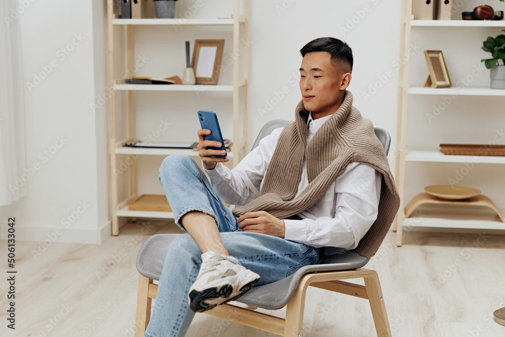 handsome man home with smartphone in chair interior internet Lifestyle