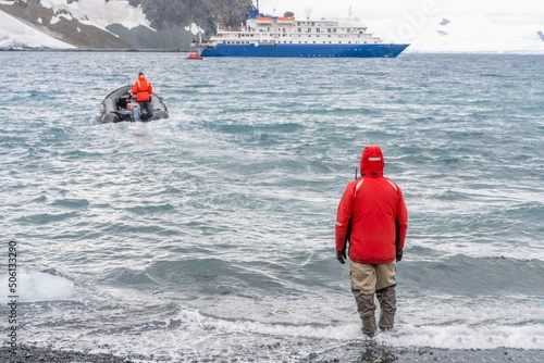 Antarktis Expedition, die Kreuzfahrtpassagiere auf Deception Island landen mit Zodiacs, von einem Expeditionskreuzfahrtschiff, das in der Bucht auf den Shetlandinseln in der Antarktis festgemacht ist photo