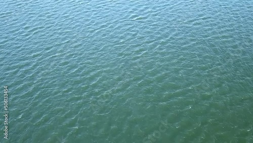 aerial footage of the silky green rippling waters of Castaic Lake with sunlight on the water in Castaic California USA photo