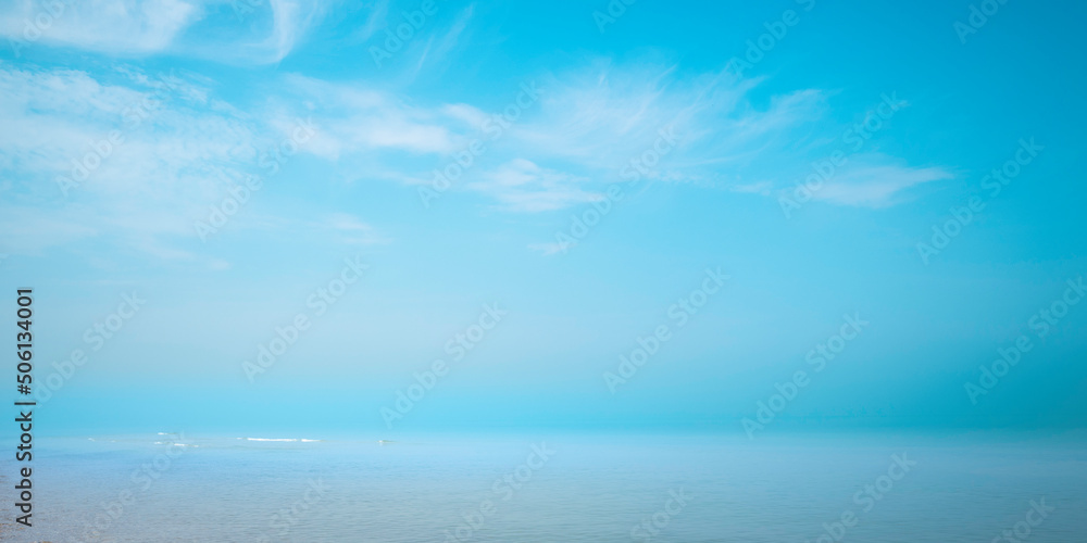 Blue seascape with dramatic clouds and fog. Tranquil summer ocean landscape in Cape Cod Bay in Massachusetts.