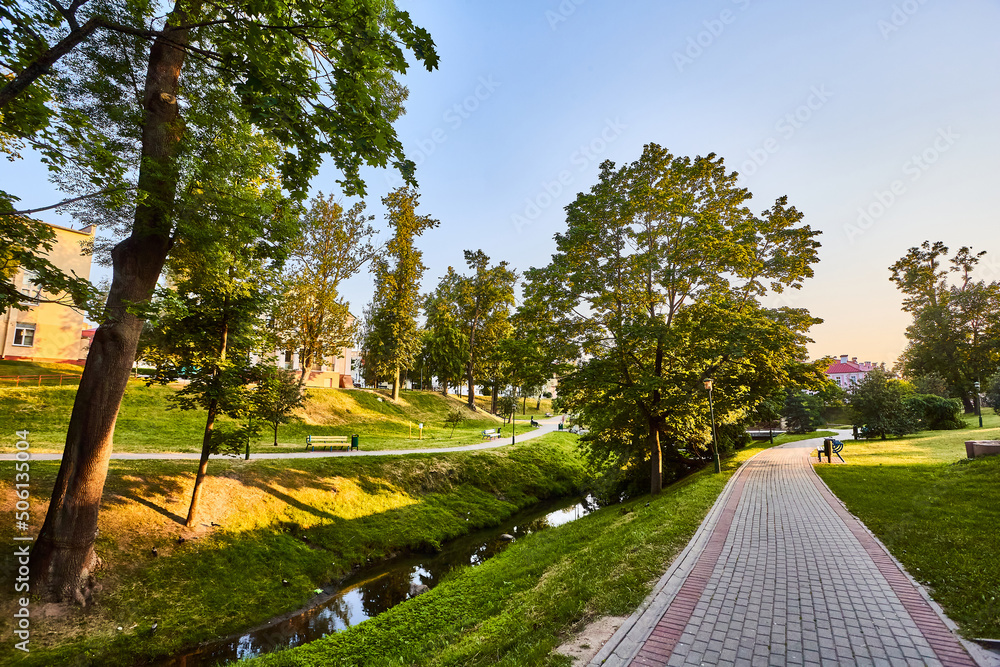 Fototapeta premium Urban landscape. A pleasant summer evening in the park. A place to rest after work