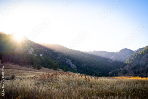 Beautiful sunset light over a field and distant mountains in the front range of Colorado