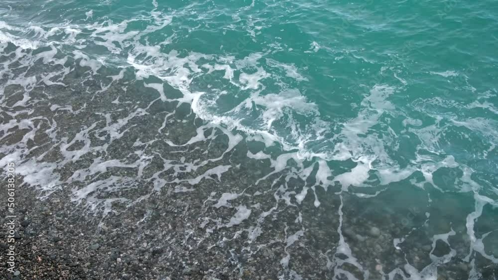 Turquoise sea beach. The purest warm ore rolls onto the pebble beach in close-up. Sparkling ocean waves. The concept of rest, relaxation, privacy. Perfect pure water. Natural tropical background. Turquoise sea beach. The purest warm ore rolls onto the pebble beach in close-up. Sparkling ocean waves. The concept of rest, relaxation, privacy. Perfect pure water. Natural tropical background.