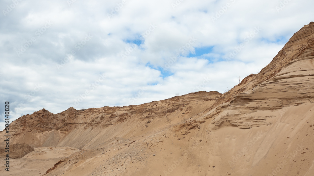 a sand quarry, in the photo a sand quarry and a gray sky in the background