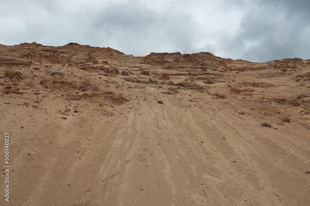 a sand quarry, in the photo a sand quarry and a gray sky in the background