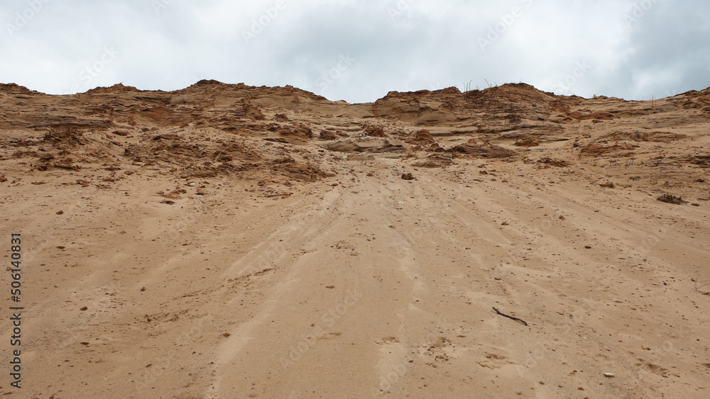 a sand quarry, in the photo a sand quarry and a gray sky in the background a sand quarry, in the photo a sand quarry and a gray sky in the background