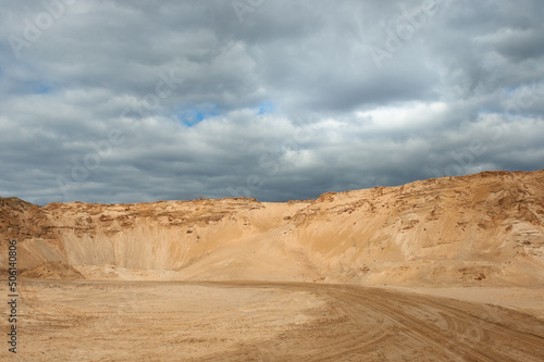 a sand quarry, in the photo a sand quarry and a gray sky in the background