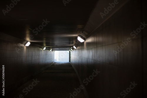 Tunnel with lamps. Long tunnel in building.