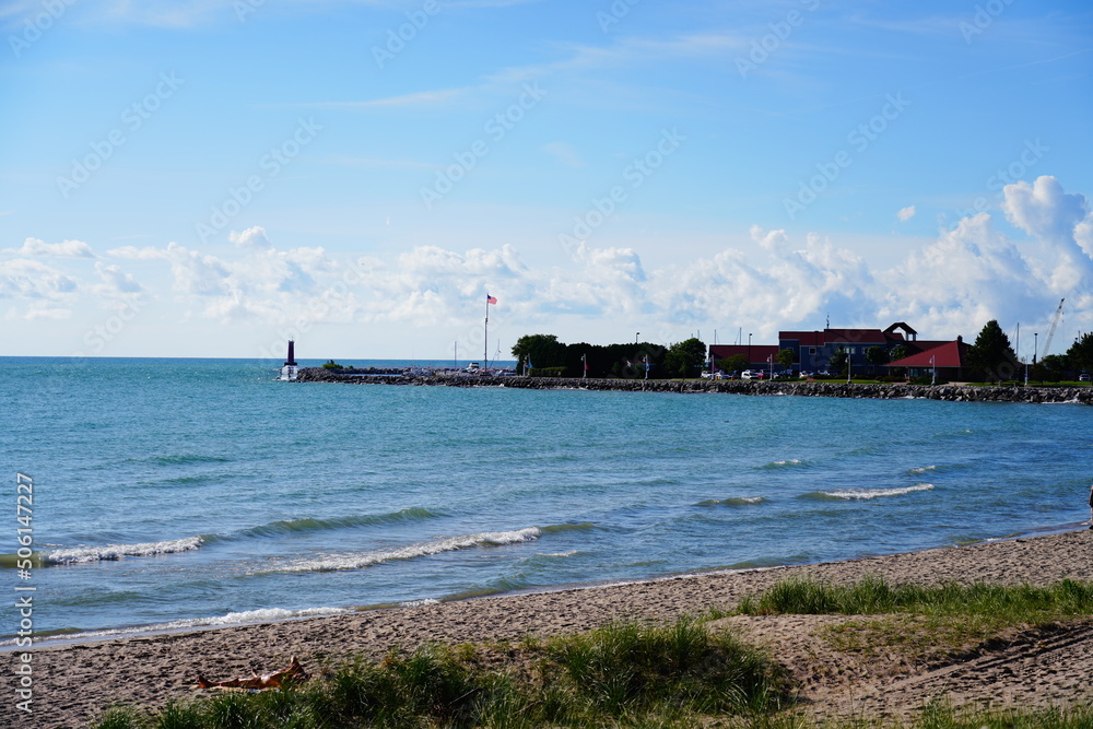 Sandy beach is on the shoreline of Lake Michigan in Sheboygan, Wisconsin.
