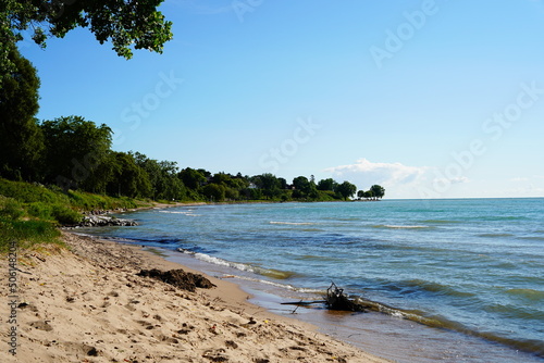 Sandy beach is on the shoreline of Lake Michigan in Sheboygan, Wisconsin.