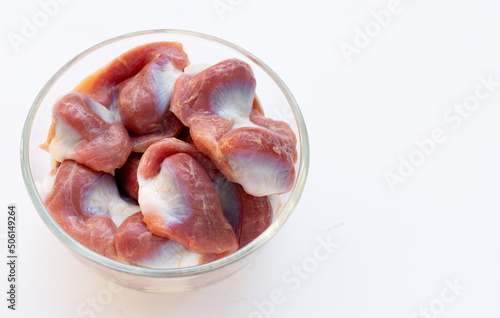 Raw Chicken gizzards in glass bowl on white background..