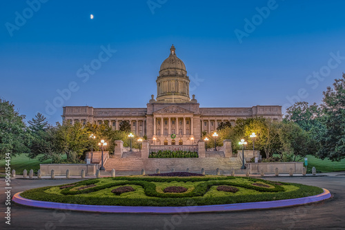 Illuminated Kentucky State Capitol at dusk with warm lights illuminating this great capitol with a blue sky  on a warm summer evening in Frankfort, KY.