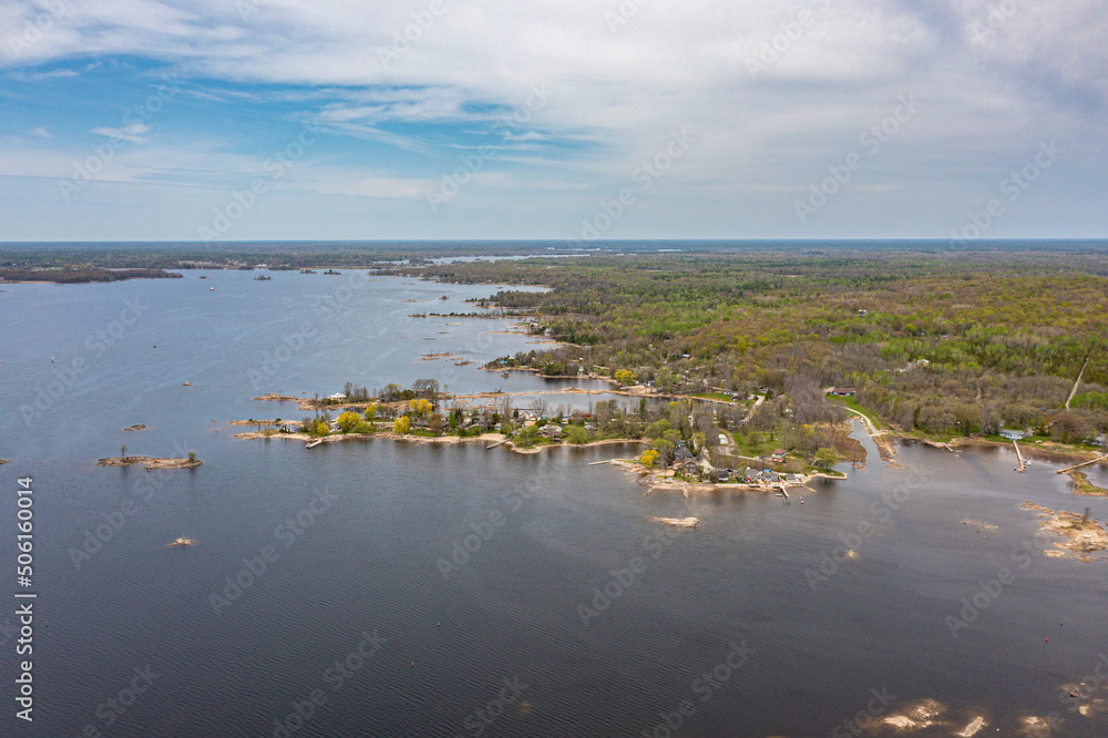 Georigian bay  drone photos with beaches and islands  by waubaushene beach going into lake huron with clouds and blue skies 