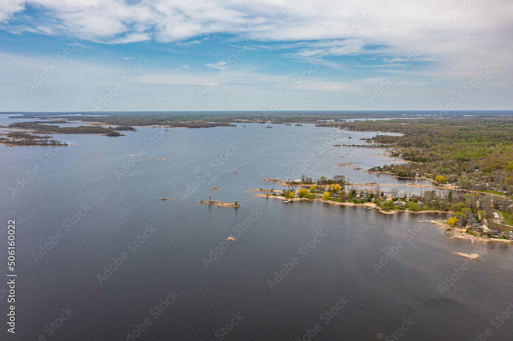 Georigian bay  drone photos with beaches and islands  by waubaushene beach going into lake huron with clouds and blue skies 