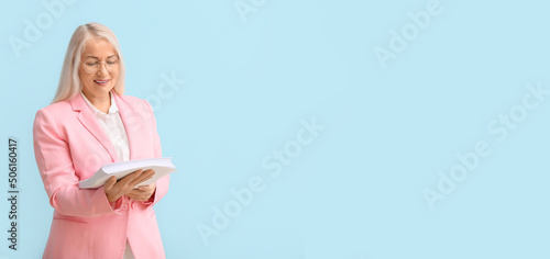 Mature secretary holding pa...