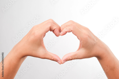 Female hands making sign Heart by hands on white background. Heart with hands with copy space. Love concept on Valentine day.