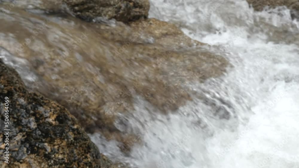 water flowing into the rocks water flowing into the rocks