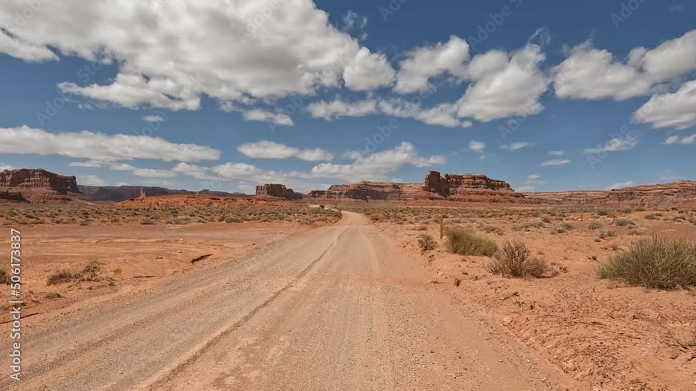Valley of the Gods Utah car driving POV. Scenic sandstone valley southeastern Utah desert landscape. Enchanting rock and stone natural formations. Camping, hiking, exploring adventure. Dry wilderness. Valley of the Gods Utah car driving POV. Scenic sandstone valley southeastern Utah desert landscape. Enchanting rock and stone natural formations. Camping, hiking, exploring adventure. Dry wilderness.