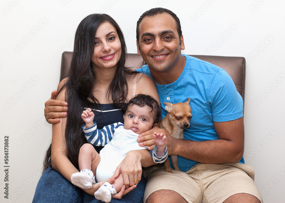 Studio portrait of a young family with a dog on a white background. High quality photo Studio portrait of a young family with a dog on a white background. High quality photo