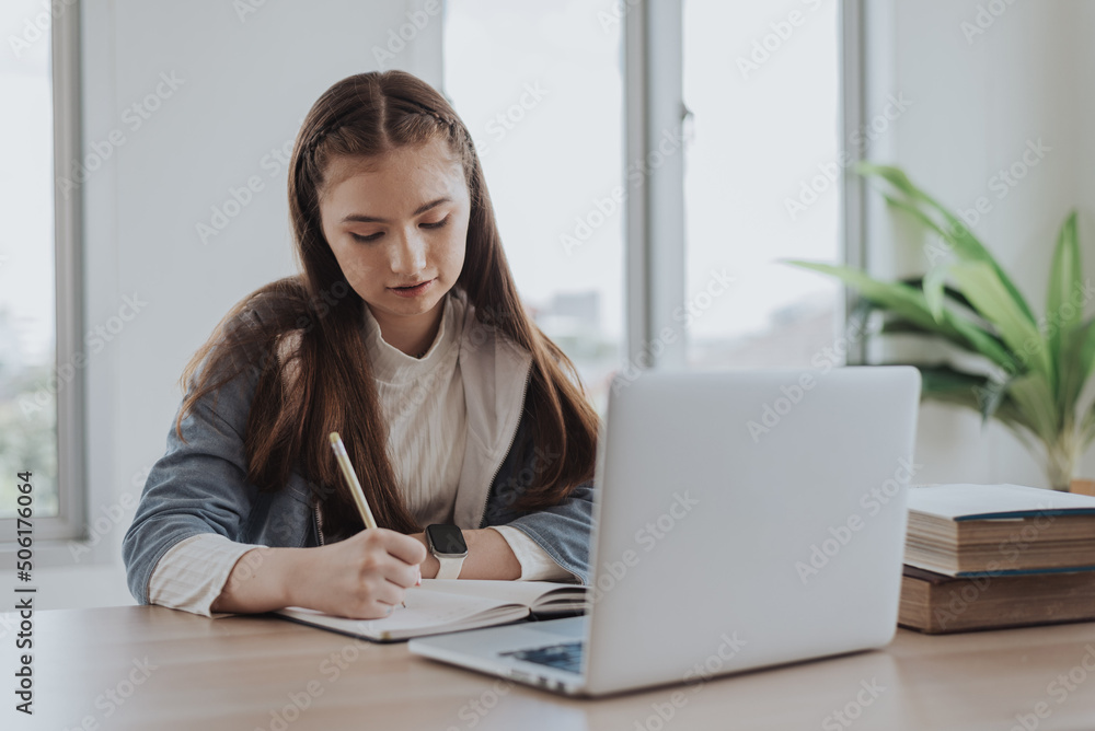 Caucasian girl learning online class from school. girl using laptop learning online education from home.