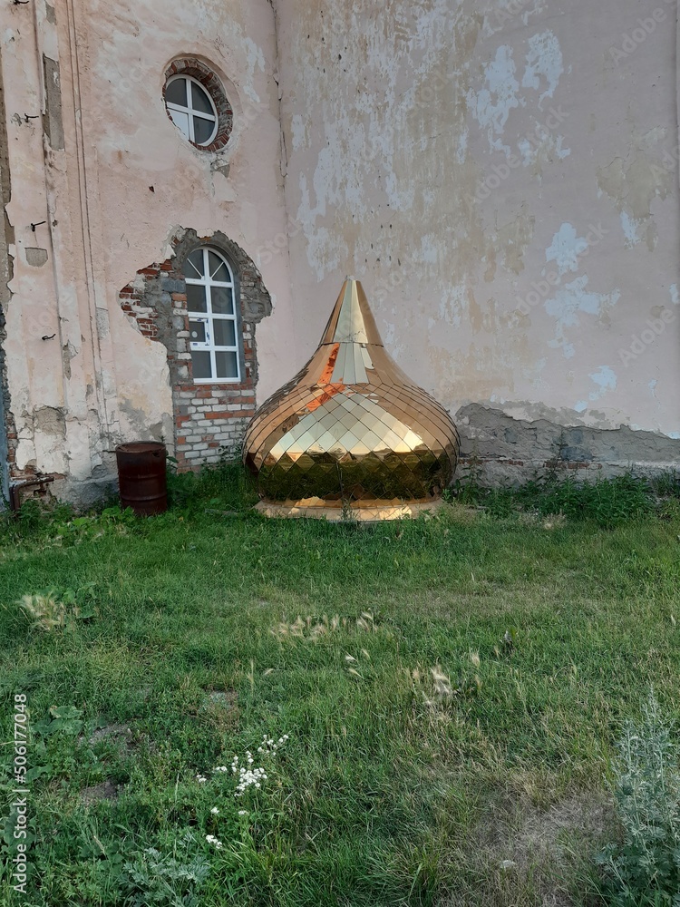 The golden dome of the temple is waiting for installation