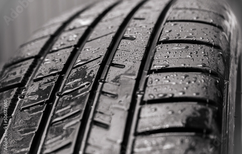 Close-up of a car tire with raindrops. Selective focus, shallow depth of field