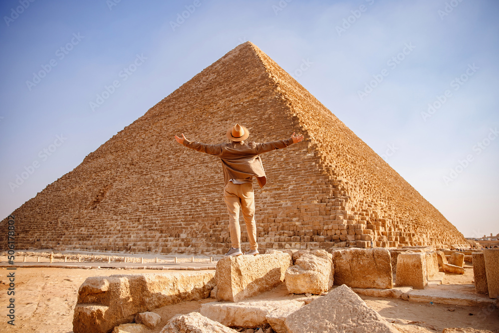 Travel man in hat stand background Egyptian pyramid sunset Giza Cairo Egypt Stock Photo Adobe Stock