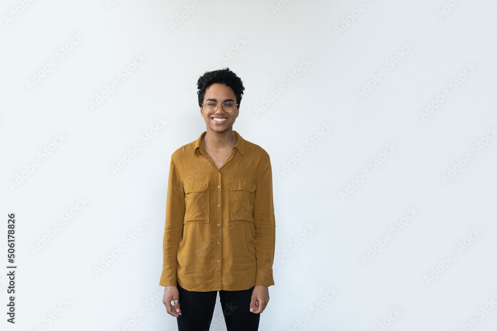 Beautiful woman in casual clothes posing alone on gray background having candid smile look at camera advertise eyewear, vision check up. Happy African female, studio shot portrait, white copy space Beautiful woman in casual clothes posing alone on gray background having candid smile look at camera advertise eyewear, vision check up. Happy African female, studio shot portrait, white copy space
