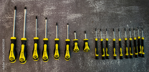 Professional set of screwdrivers on a gray background