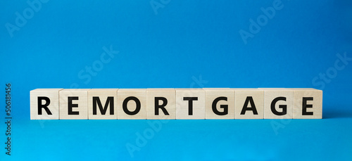 Remortgage symbol. Wooden blocks with word Remortgage. Beautiful blue background. Business and Remortgage concept. Copy space. photo