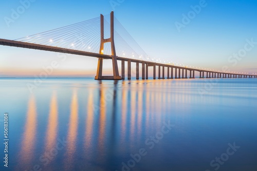 Background on the Lisbon bridge. The Vasco da Gama Bridge is a landmark, and one of the longest bridges in the world. Urban landscape. Portugal is an amazing tourist destination © Michal