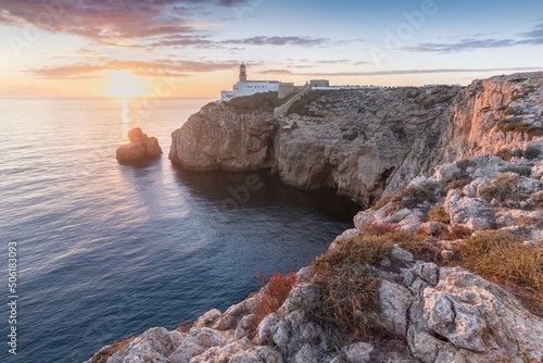 View on lighthouse by Cabo de Sao Vicente. Sagres, Algarve, Portugal.
Beautiful lighthouse located on high cliffs of Saint Vincent cape. Summer season. photo