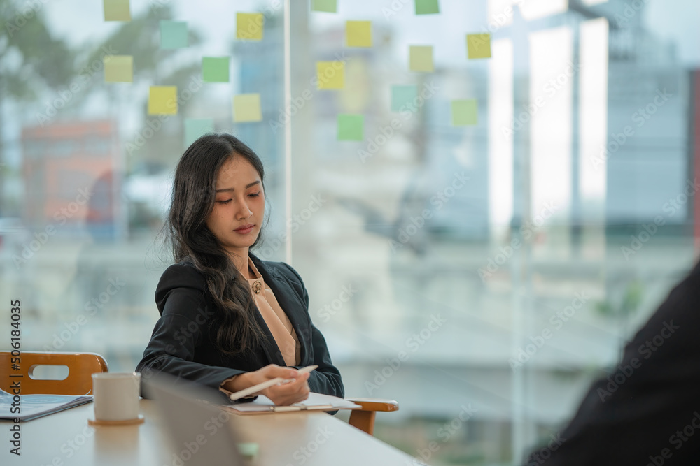 Businesswoman getting bored while attending presentation. Businesswoman getting bored while attending presentation.