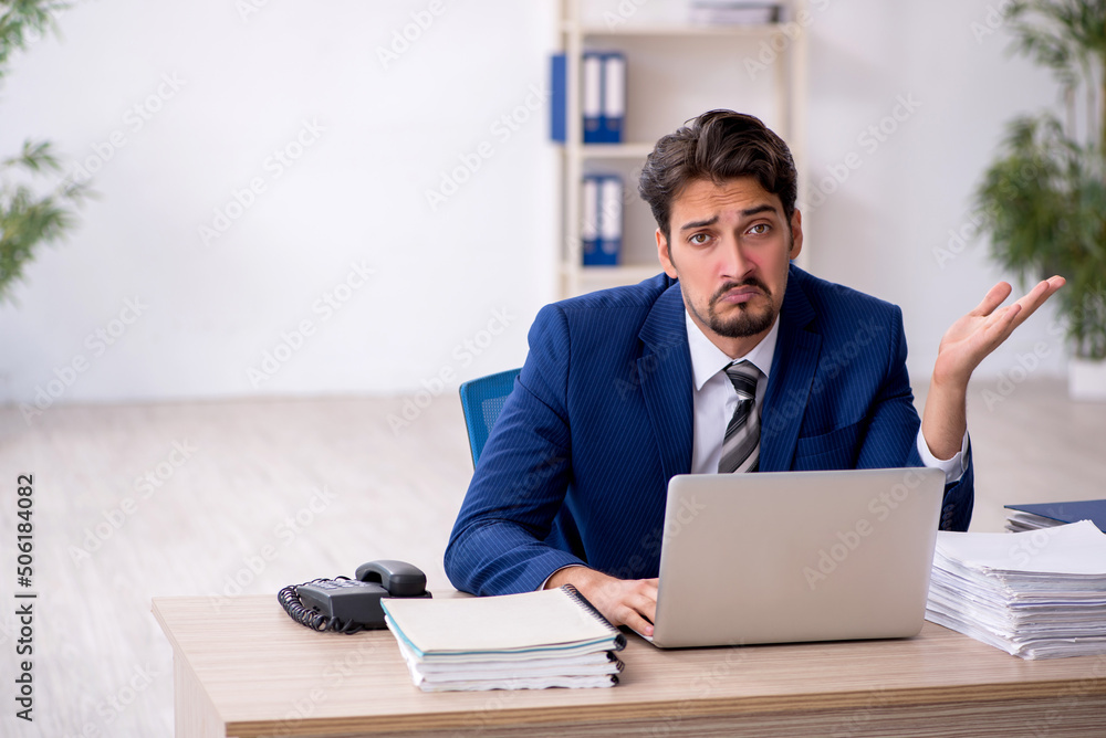 Young male employee working in the office Young male employee working in the office