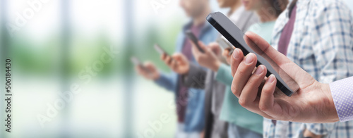 People using smartphones in the city street