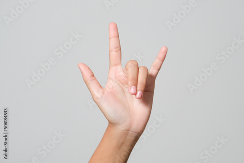 Woman's hand giving the Rock and Roll sign, devil horns gesture