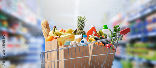Shopping cart full of groceries photo