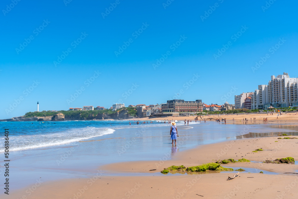 An elderly woman walking on the beach in Biarritz, Lapurdi. France, South West resort town