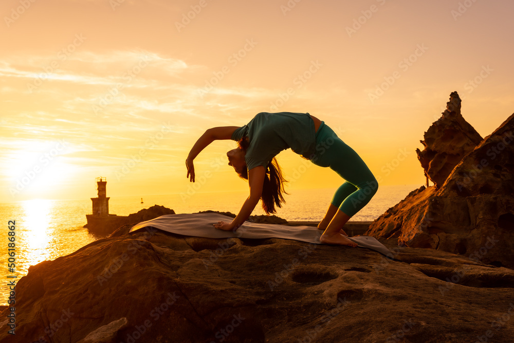 Urdhva Dhanurasana, a woman doing meditation and yoga exercises on a