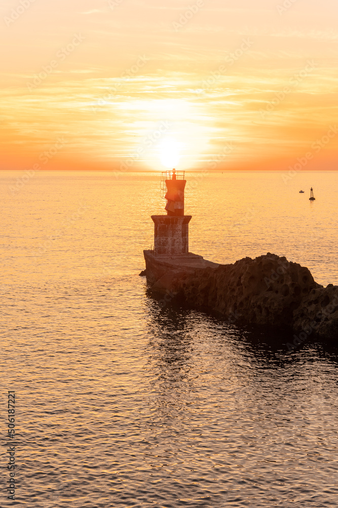 Beautiful orange sunset at the Lighthouse of the bay of Pasaia in the town of San Juan. Gipuzkoa. Basque Country
