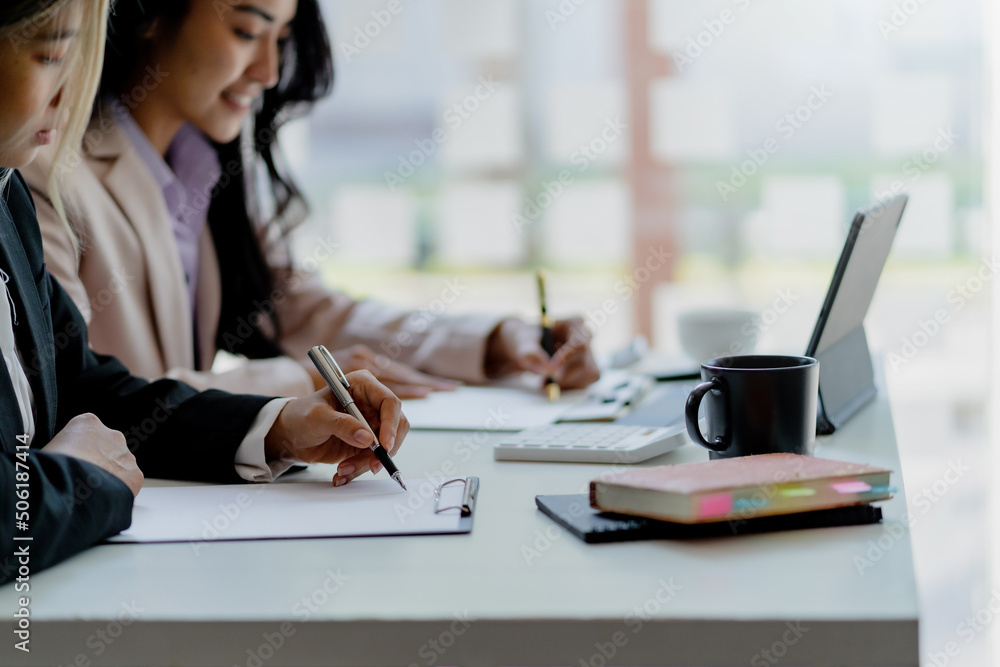 Two young Asian business woman talk, consult, discuss working with new startup project idea presentation analyze plan marketing and investment in the office. Two young Asian business woman talk, consult, discuss working with new startup project idea presentation analyze plan marketing and investment in the office.