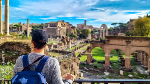 Photography Tourist man with panoramic view on ancient ruins of Roman Forum