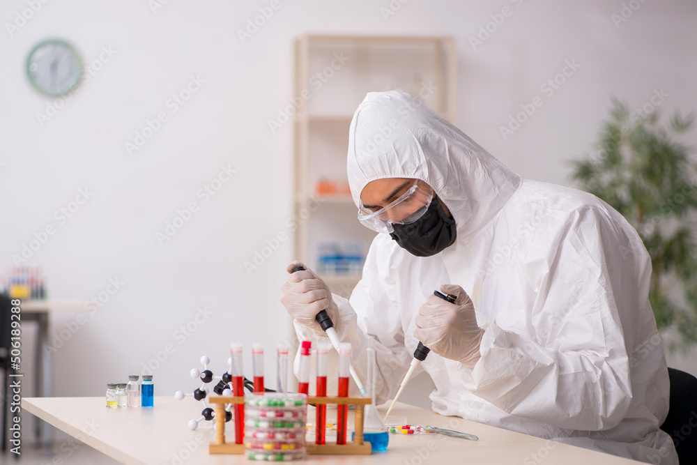 Young male chemist in drugs synthesis concept Young male chemist in drugs synthesis concept