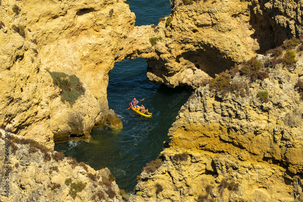 Panoramic view with Cliff, rocks and kayak boat on sea at Ponta da Piedade near Lagos, Algarve, Portugal