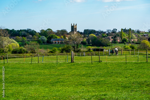 English countryside with St Andrew's church in the distance in Whissendine village in Rutland, England photo