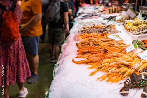 Fresh seafood on ice at the Boqueria market in Barcelona (Spain), selective approach to shrimp.