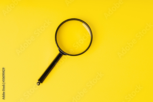 Magnifying glass on a yellow background. Minimalistic image